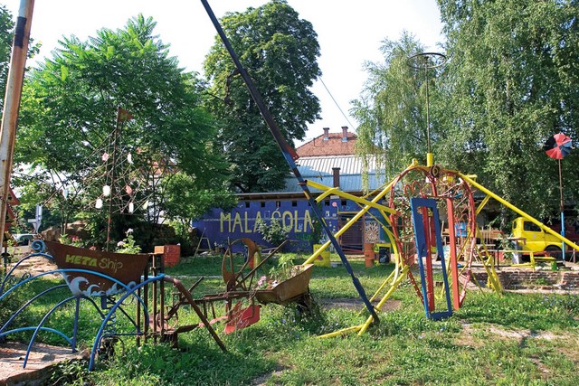 Mala šola pred rušenjem, pred njo skulptura