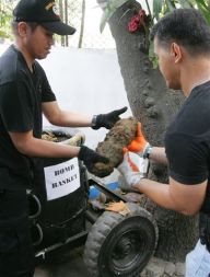 Filipinska policista previdno prenašata bombo iz II. svetovne vojne. Med gradnjo ameriškega veleposlaništva v Manili so gradbeni delavci našli okoli 100 od rje razjedenih bomb.