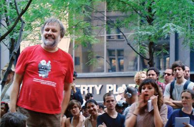 Filozof Slavoj Žižek v nedeljo, 9. oktobra, v parku Zuccotti, ki stoji med ničelno točko in newyorško borzo, kjer je središče gibanja Zavzemimo Wall Street. Ker protestniki ne uporabljajo ozvočenja, se misli govorca širijo tako, da tisti, ki so najbližje govorcu, glasno ponavljajo njegove stavke. Tako je bilo tudi, ko je nastopil Žižek.