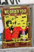 Plakat na protestu proti Angeli Merkel v Lizboni