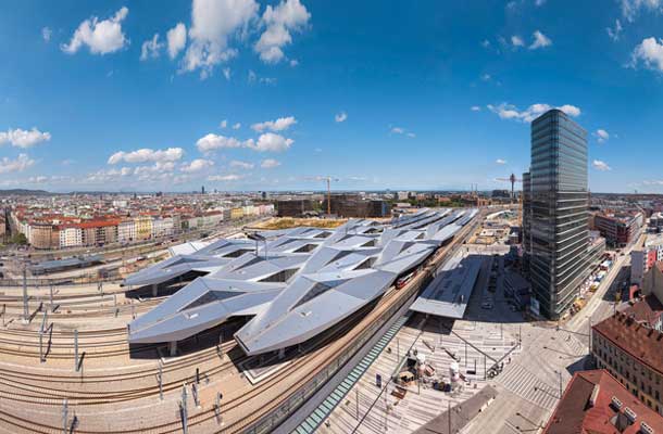 Wien Hauptbahnhof, leta 2014 odprta nova dunajska glavna železniška postaja, ki je nastala s povezavo linij Južne in Vzhodne železnice in združitvijo njunih končnih postaj. Tiri so dvignjeni nad raven mestnega parterja, da lahko pod njimi nemoteno potekajo cestne in peš povezave, nad peroni pa lebdi ekspresivna valovita poligonalna aluminijasta streha. 