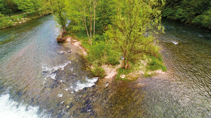 Otok, na katerem je bil ujet begunec, ki mu je deroča voda na slapu spodnesla noge in je omahnil v mrzlo reko.