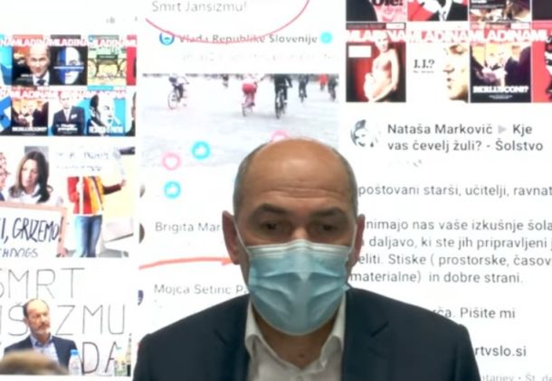 Janez Janša med videoklicem z ozadjem, na katerem lahko opazite tudi naslovnice Mladine