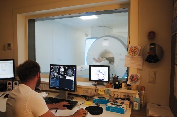 Radiolog v podjetju Medilab slika z magnetnoresonančnin aparatom. 