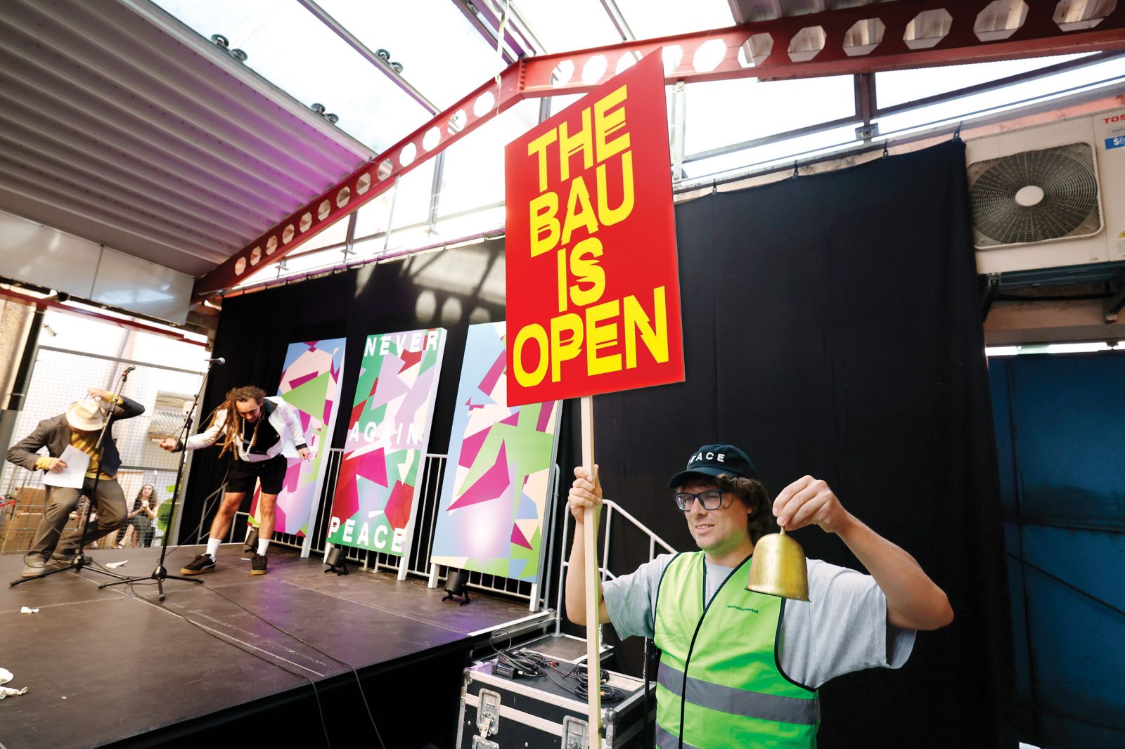 Nekdanjo destilarno so za čas festivala poimenovali BAU, kar je v nemščini brlog, gradbišče, celo zapor. Lahko pa je tudi metafora sodobne družbe, ki je razdeljena, a skupaj plove proti negotovi prihodnosti.